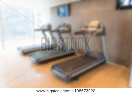 Abstract blur Fitness center with traineger equipments