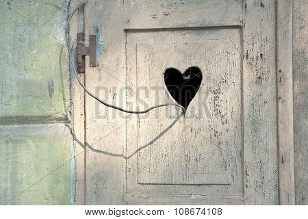old wooden door in meran Tirol Italy with a carved romantic heart