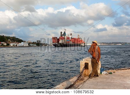 HAVANA, CUBA - MAY 19: Unknown Cuban fisherman catches a fish at the Malecon seawall on May 19, 2013 in Havana, Cuba. Fishing in the city helps to replenish the meager diet of poor people in Havana
