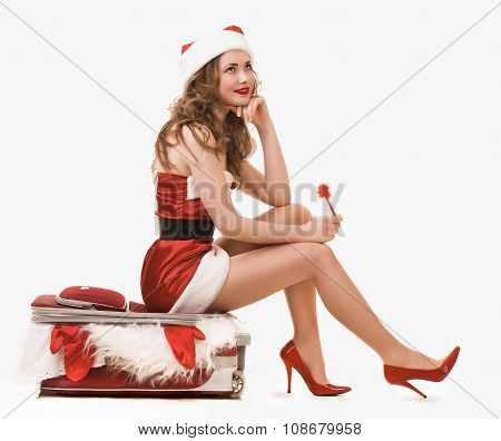 Beautiful snow maiden in fashionable dress  with a suitcase