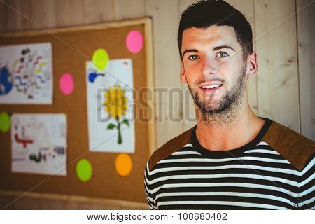 Man standing in the office by a noteboard