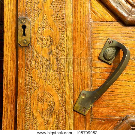 The Travedona Monate Rusty Brass Brown Knocker In A  Door