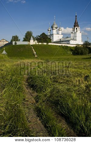 Summer Landscape With An Old Monastery And Walking Nun