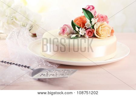 Cake with sugar paste flowers, on light background