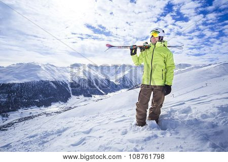 Sporty men with skis in a snow mountain resort