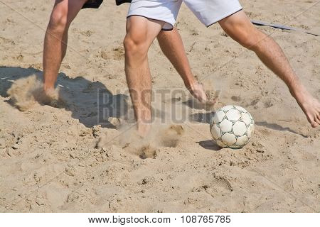 Beach soccer legs and ball