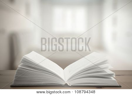 open book on old wooden table in the bedroom