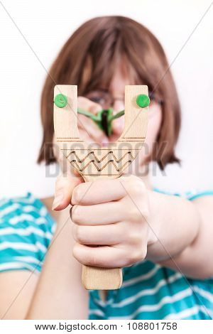 Front View Of Girl Shooting From Wooden Slingshot