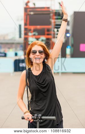 Ctive Cheerful Girl On A Scooter In A City Location