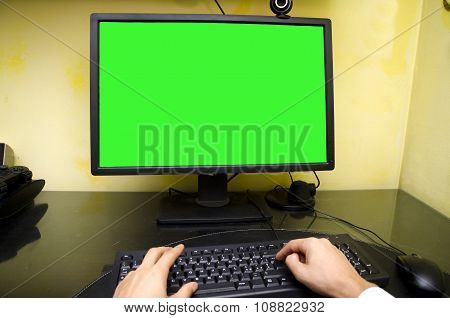 POV of worker sitting at his desk working at computer
