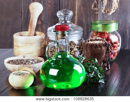 Therapeutic Herbal Tincture, Alternative Medicine, Love Potions, Dried Herbs On A Wooden Table.