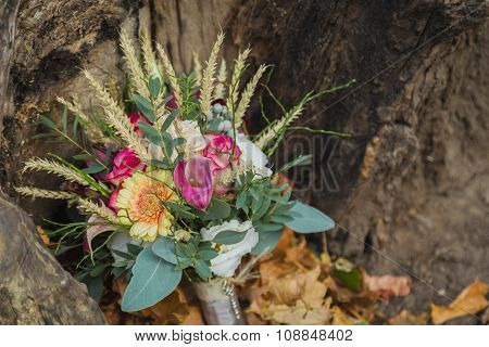 Wedding bouquet on the yellow leaves