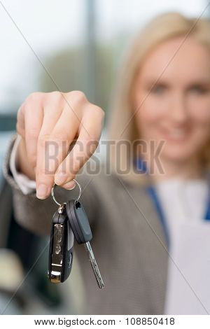Saleswomans hand grasping the car keys.
