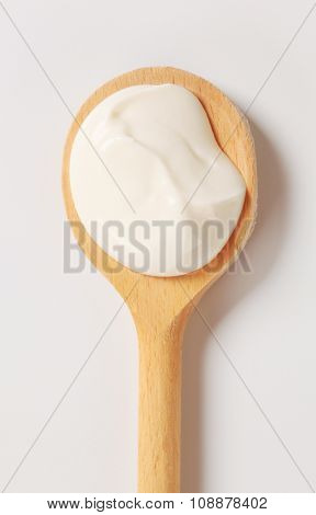 Creme fraiche on a wooden spoon