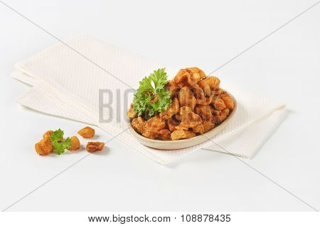 plate of salty pork greaves on white napkin