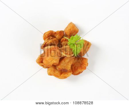 pile of pork greaves on white background