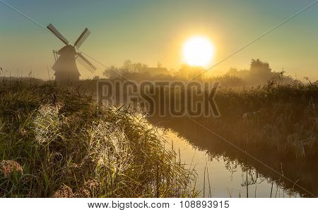 Windmill In Marshland With Cobwebs