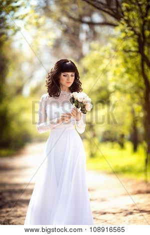 Beautiful bride in white dress in the garden