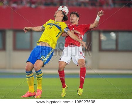 VIENNA, AUSTRIA - SEPTEMBER 9, 2014: Aleksandar Dragovic (#3 Austria) and Zlatan Ibrahimovic (#10 Sweden) fight for the ball in an European Championship qualifying game.