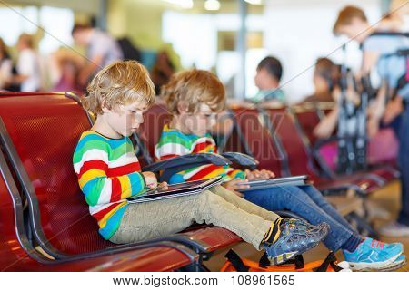Two tired little sibling boys at the airport