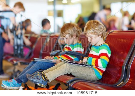 Two tired little sibling boys at the airport