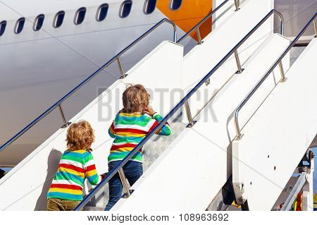 Two tired little sibling boys at the airport