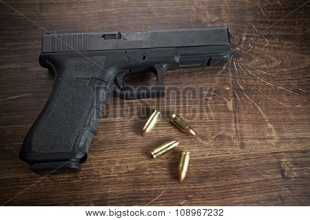 Pistol gun on wooden background