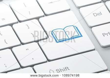 Studying concept: Book on computer keyboard background