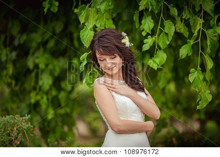 Beautiful bride in white dress in the garden