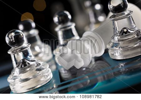 Overthrown King On Blue Chessboard With Crooked Angle And Bokeh