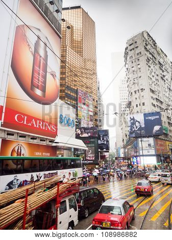 People  Walk In The Rain At Busy Streets Of Causeway Bay .