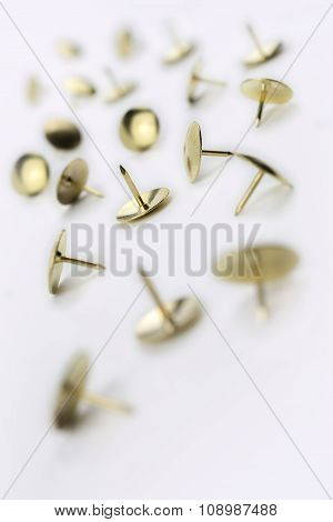 A Small Collection Of Thumbtacks In A White Box - Crooked Angle