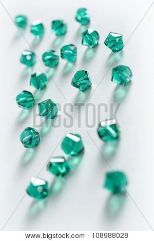 Collection Of Many Green Double Cones Crystals In A White Box