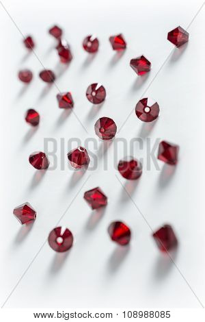 Collection Of Many Red Double Cones Crystals In A White Box