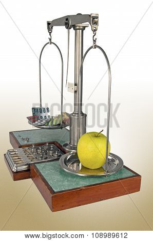 Old Style Pharmacy Scale With Yellow Apple Heavier Than Drugs