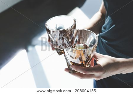 Person Holding Glasses Of Cognac