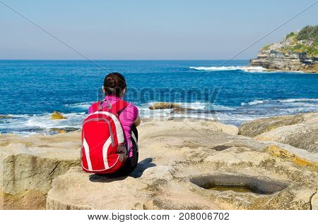 Young woman seen from behind oceanfront of bondi beach SydneyAustralia.