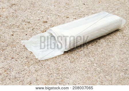 a newspaper package delivery on a driveway.