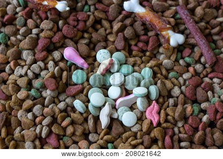 Vitamin tablets for pets on hip of dry pet food