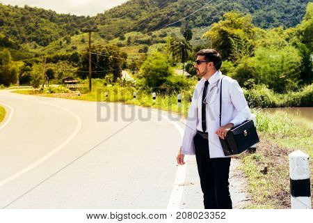 Asia young docter are standing at rural road .Community Health and Development Hospital In Remote Areas Development Fund Concept.