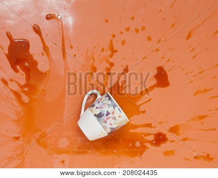 coffee spilled from big cup to the floor