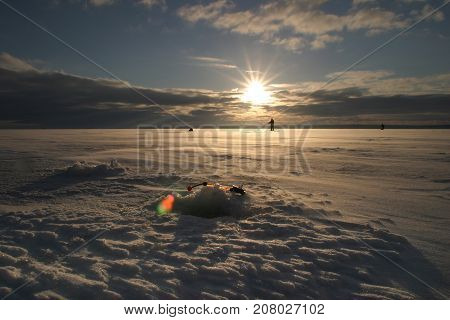 Fisherman On The River Covered With Ice
