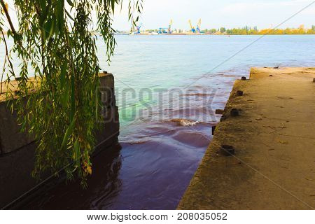 The riverscape of large drainage steel pipe background. concept of industrial wastes and environmental pollution