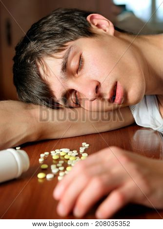 Young Man sleep with a Pills at the Home