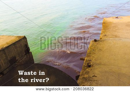 The riverscape of large drainage steel pipe background. concept of industrial wastes and environmental pollution