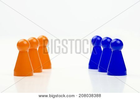 Close-up photo of a group of different-colored pieces in different positions on a white background - applicable to the team view