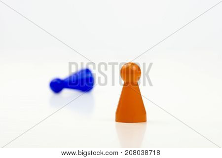 Close-up photo of a group of different-colored pieces in different positions on a white background - applicable to the team view