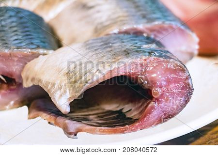 Pieces of fish, Pieces of herring on the plate. Selective focus