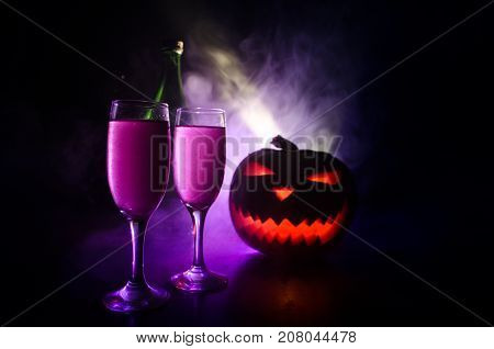 Two Glasses Of Wine And Bottle With Halloween - Old Jack-o-lantern On Dark Toned Foggy Background. S