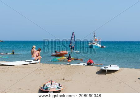 RHODES, GREECE - AUGUST 2017: Surfers at coast of Rhodes island in Prasonisi district, Greece